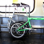 My signal green steel Swift Folder next to an aluminum Xootr Swift.