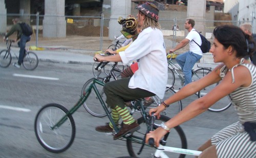 Playing a horn on 2nd, under the freeway.